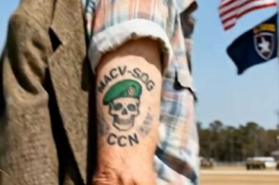 On a blazing Carolina morning at Fort Bragg, the kind of day where the air feels like wet wool and the flags slap the sky like they’re angry at it, an old man in a worn tweed jacket stood exactly where he wasn’t supposed to be.
