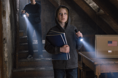 My mom decided my real dad was “gone” the second the cell door closed. She brought home her new boyfriend like a replacement part and told me to start calling him “dad,” as if a word could erase an entire life. But while she was busy rewriting my last name and my future, I was still talking to my real father in secret—and the night his message told me to check the attic, I found something hidden behind the radiator… right as Brandon’s footsteps started climbing the stairs.